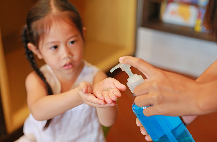 Child receiving hand sanitizer